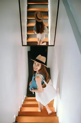 a young girl is walking down the stairs at The Front Hotel and Apartments in Patong Beach