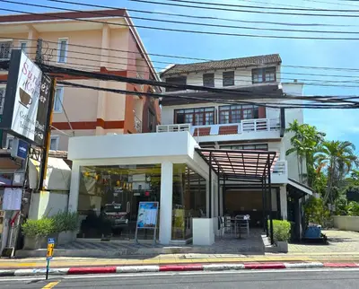 a building with a store on the side of the street at Sunset Mansion in Patong Beach