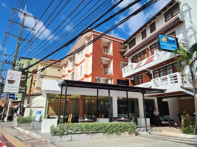 a building with a cafe in front of it at Sunset Mansion in Patong Beach