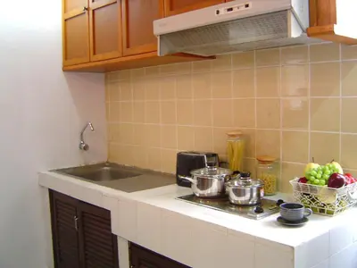 a kitchen counter with pots and pans on a stove at Sunset Mansion in Patong Beach