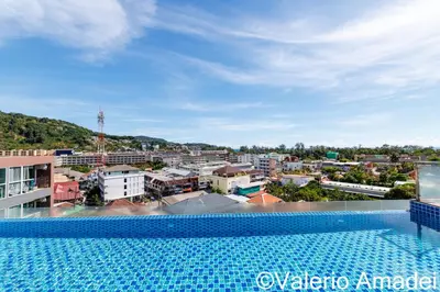 a view of the city from the swimming pool of a building at Ozone Condotel Kata Beach by PHR in Kata Beach