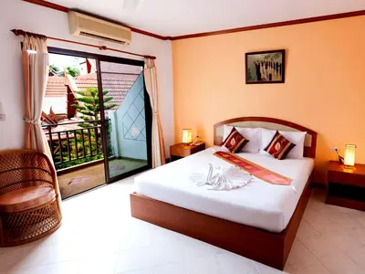 a bedroom with a bed and a balcony at Sai Rougn Residence - SHA Extra Plus in Patong Beach