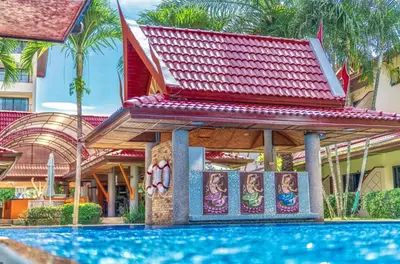 a resort with a pool in front of a building at Sai Rougn Residence - SHA Extra Plus in Patong Beach