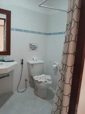 a bathroom with a toilet and a sink at Sai Rougn Residence - SHA Extra Plus in Patong Beach