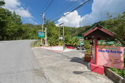 an empty road with a sign on the side of it at Patong Rai Rom Yen Resort SHA in Patong Beach