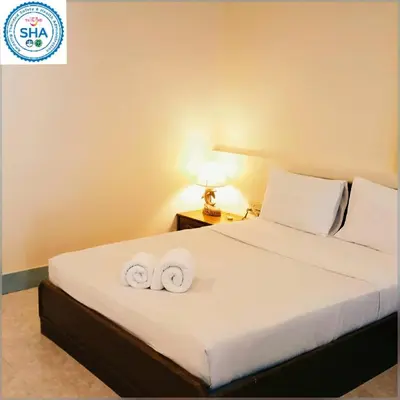 a bedroom with a bed with two towels on it at Baan Pron Phateep in Patong Beach