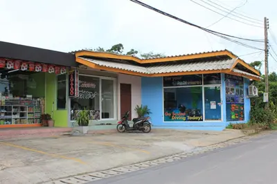 a store with a motorcycle parked in front of it at Phuket Muay Thai House in Chalong