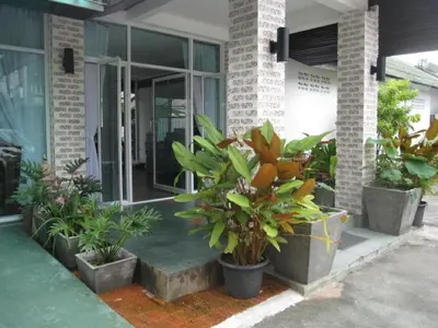a group of potted plants sitting outside of a building at Hacienda Phuket, Patong in Patong Beach
