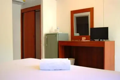 a room with a bed and a green refrigerator at Hacienda Phuket, Patong in Patong Beach