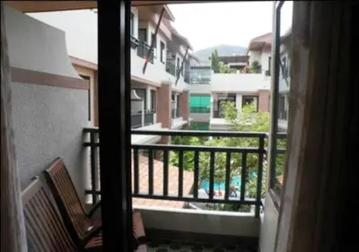 a balcony with a view of a building at P.P. Palmtree Resort in Phi Phi Don