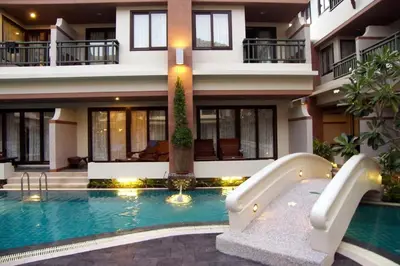 a house with a swimming pool in front of a building at P.P. Palmtree Resort in Phi Phi Don