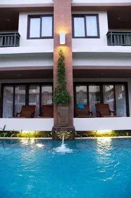 a house with a swimming pool in front of a building at P.P. Palmtree Resort in Phi Phi Don