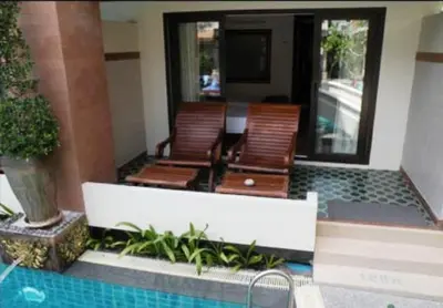 a patio with two chairs and a swimming pool at P.P. Palmtree Resort in Phi Phi Don