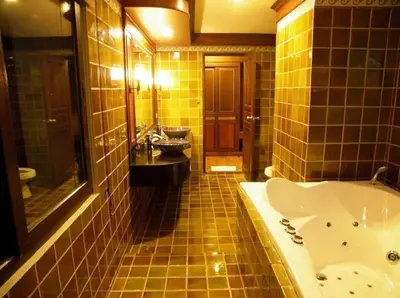 a bathroom with a tub and a toilet and a sink at P.P. Palmtree Resort in Phi Phi Don