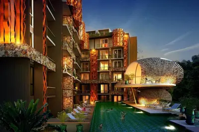a hotel with a swimming pool in front of a building at Emerald Terrace Patong in Patong Beach