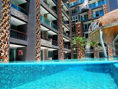 an empty swimming pool in front of a building at Emerald Terrace Patong in Patong Beach