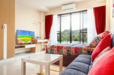 a living room with a couch and a tv at Nai Thon Condo Unit in Nai Thon Beach