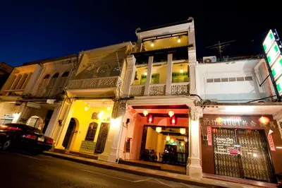 a building on the side of a street at night at 99 Oldtown Boutique Guesthouse SHA EXTRA PLUS in Phuket Town