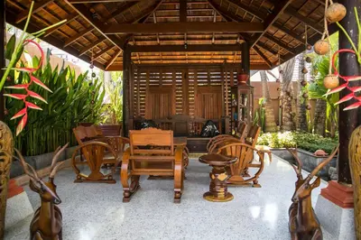a patio with chairs and a table and a room at West Key Kamala Villa in Kamala Beach
