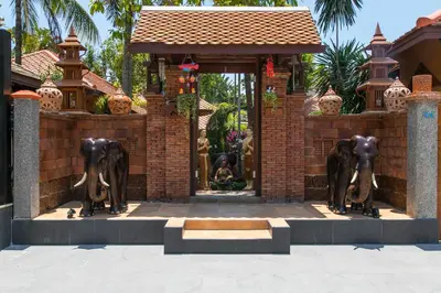 a statue of elephants in front of a building at West Key Kamala Villa in Kamala Beach