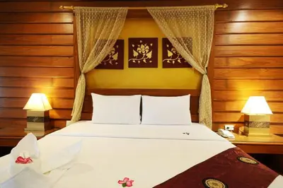 a bedroom with a large white bed with two lamps at Bel Aire Patong in Patong Beach