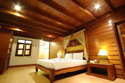 a bedroom with a bed in a wooden room at Bel Aire Patong in Patong Beach