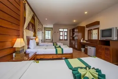 a hotel room with two beds and a television at Bel Aire Patong in Patong Beach
