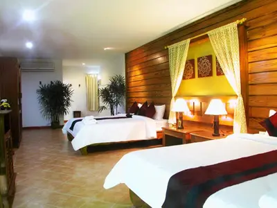 a hotel room with two beds and two lamps at Bel Aire Patong in Patong Beach