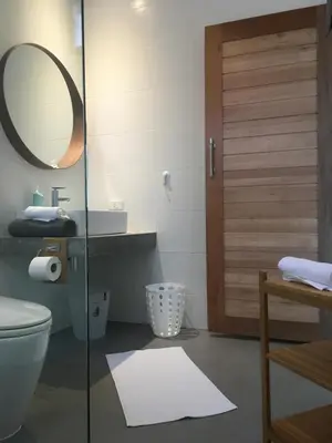 a bathroom with a toilet and a sink and a mirror at Baan Andaman Sea Surf in Patong Beach