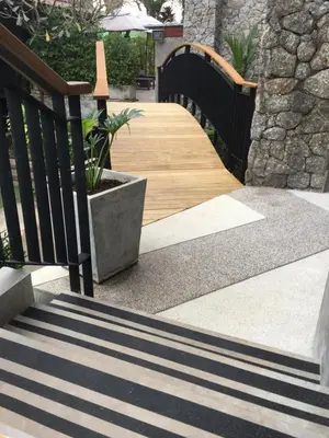 a set of stairs with a wooden walkway at Baan Andaman Sea Surf in Patong Beach