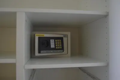 a microwave on a shelf in a room at Baan Andaman Sea Surf in Patong Beach