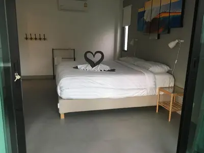 a bedroom with a bed with a heart on it at Baan Andaman Sea Surf in Patong Beach