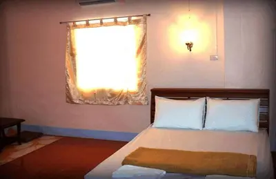 a bedroom with a bed with a window at D's Corner & Guesthouse in Phuket Town