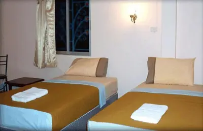 a room with two beds with towels on them at D's Corner & Guesthouse in Phuket Town