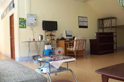 a living room with a table and a tv at D's Corner & Guesthouse in Phuket Town