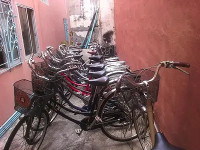 a row of bikes lined up against a wall at D's Corner & Guesthouse in Phuket Town
