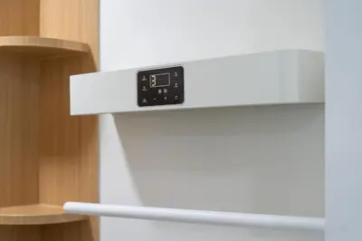 an alarm clock on the top of a refrigerator at The Color Kata in Kata Beach
