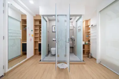 a bathroom with a glass shower and a toilet at The Color Kata in Kata Beach