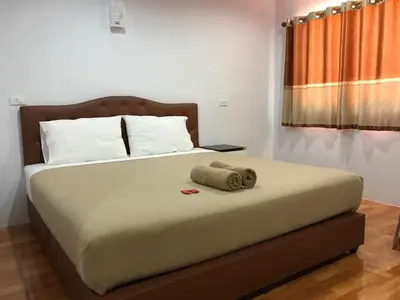 a bedroom with a bed with a towel on it at Boodsarin Hotel in Ko Yao Yai