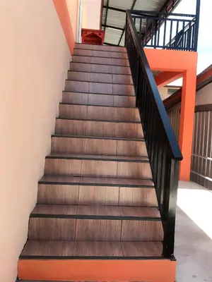 a set of stairs in a building with orange accents at Boodsarin Hotel in Ko Yao Yai