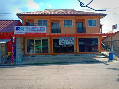 an orange building with a sign in front of it at Boodsarin Hotel in Ko Yao Yai