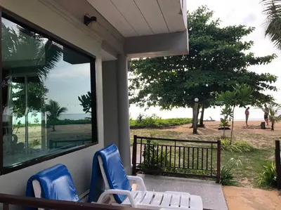 a porch with chairs and a view of the beach at Rimlay Bungalow in Nai Yang Beach