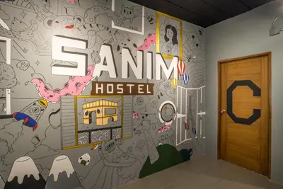 a room with a wall with a sign that reads sammi hospital at Sanim Hostel in Ao Nang Beach
