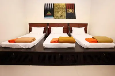 two beds sitting on top of a wooden table at Lub Sbuy Hostel in Phuket Town