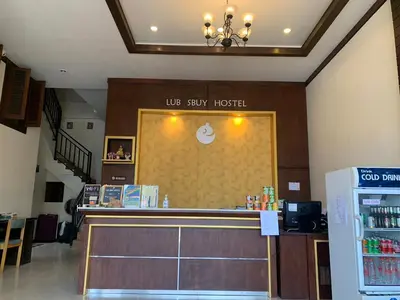 a lobby of a hotel with a reception counter at Lub Sbuy Hostel in Phuket Town