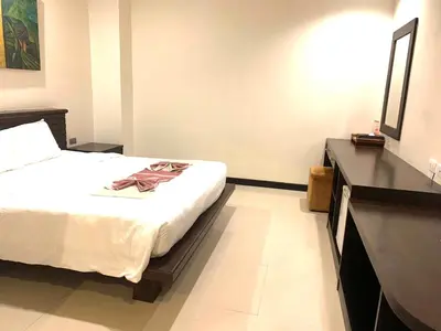 a hotel room with a bed and a black counter at Lub Sbuy Hostel in Phuket Town