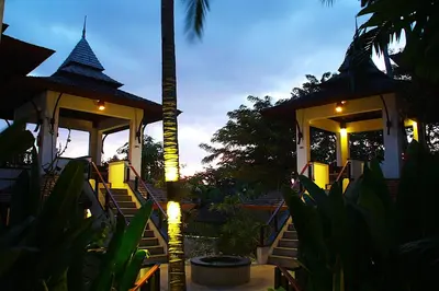 a resort with a staircase leading to a building with a palm tree at Nakamanda Resort and Spa in Klong Muang Beach