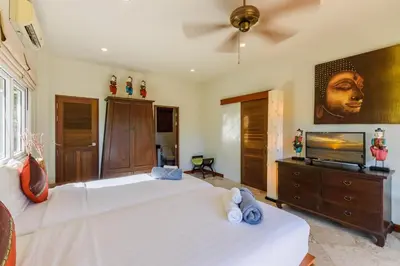 a bedroom with two beds and a flat screen tv at Aster Pool Villa Your Tropical Villa In Paradise in Rawai Beach