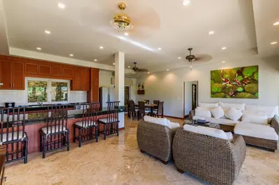 a kitchen and living room with a bar and chairs at Aster Pool Villa Your Tropical Villa In Paradise in Rawai Beach