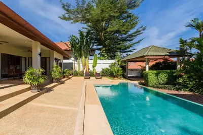 a swimming pool in front of a house at Aster Pool Villa Your Tropical Villa In Paradise in Rawai Beach